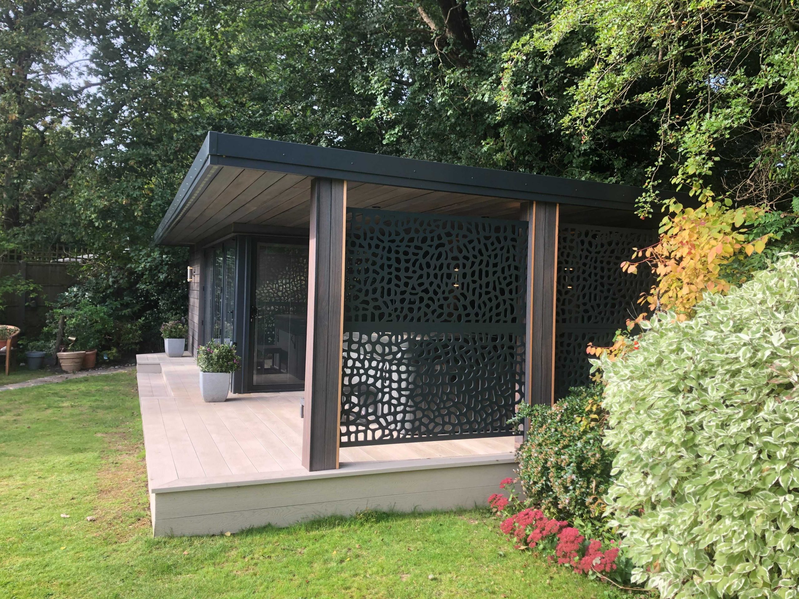 Side view of a garden room with black exteriors