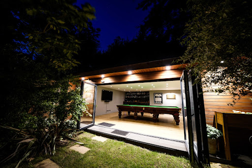 Garden room with a pool table in the dark