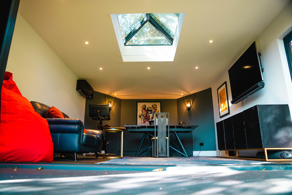 Inside of a room with skylight and black desk