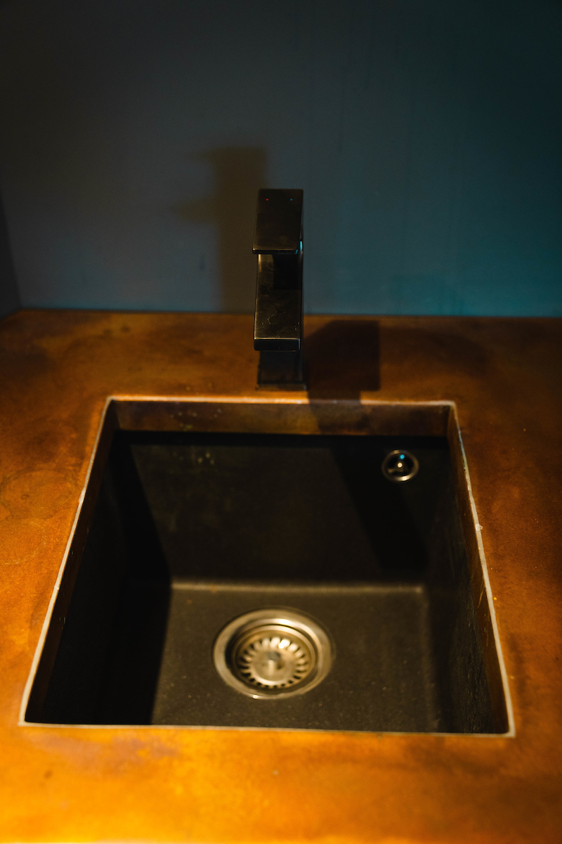 Bird's eye view of a black sink and a black tap
