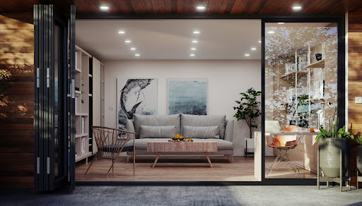 Modern garden room with a grey sofa and paintings on the wall