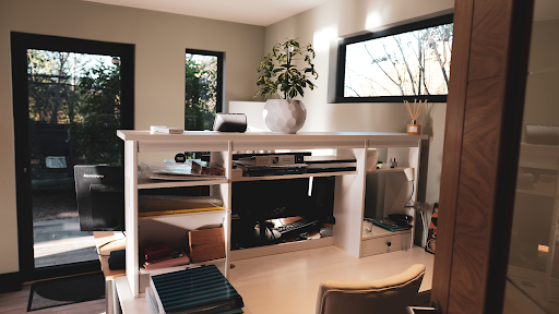 Inside of a garden office with a wooden working desk