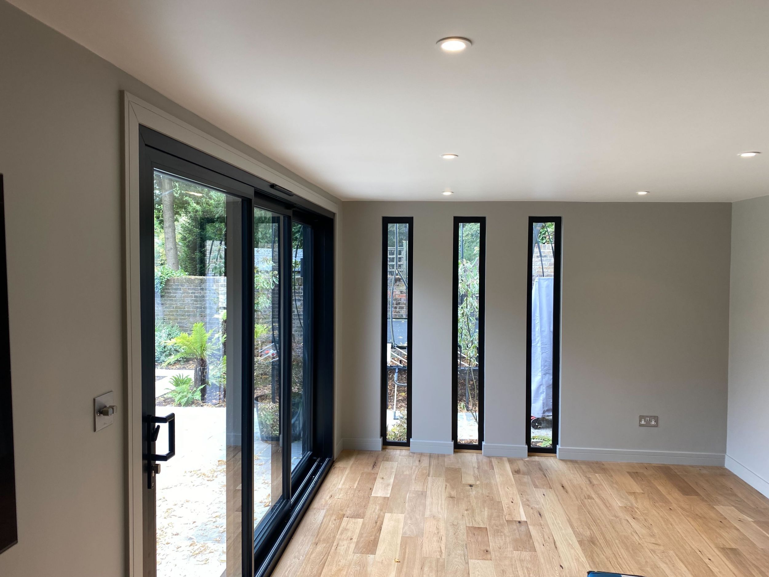 View from inside a room with white walls and glass doors