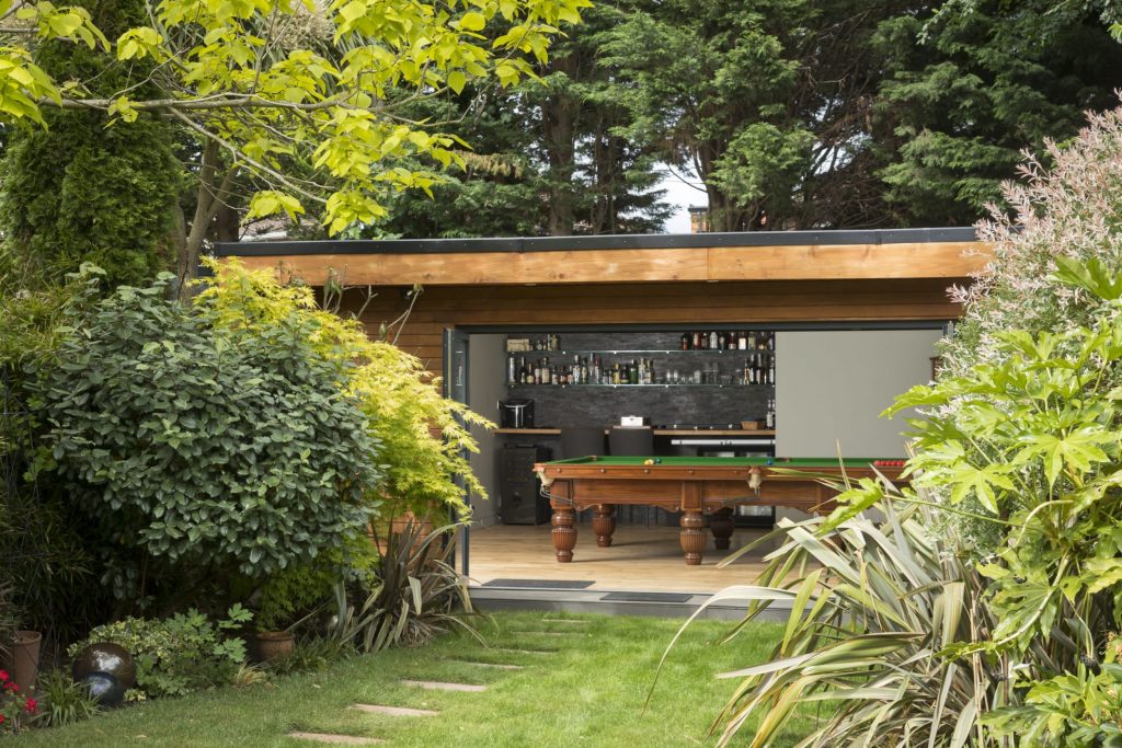 Building in the garden with pool table and drinks bar