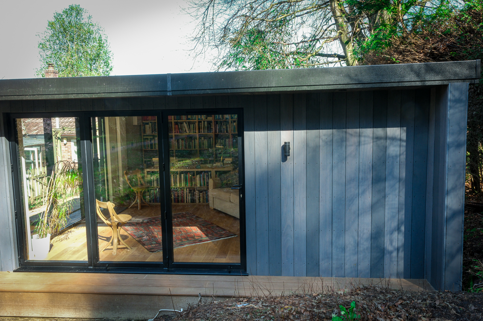 Bespoke architectural garden building with full-height glazing by Into The Garden Room
