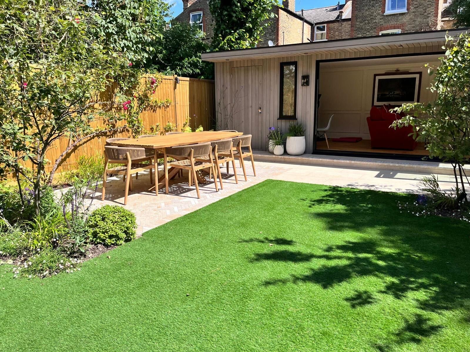 Garden outdoor living room with terrace dining by Into The Garden Room
