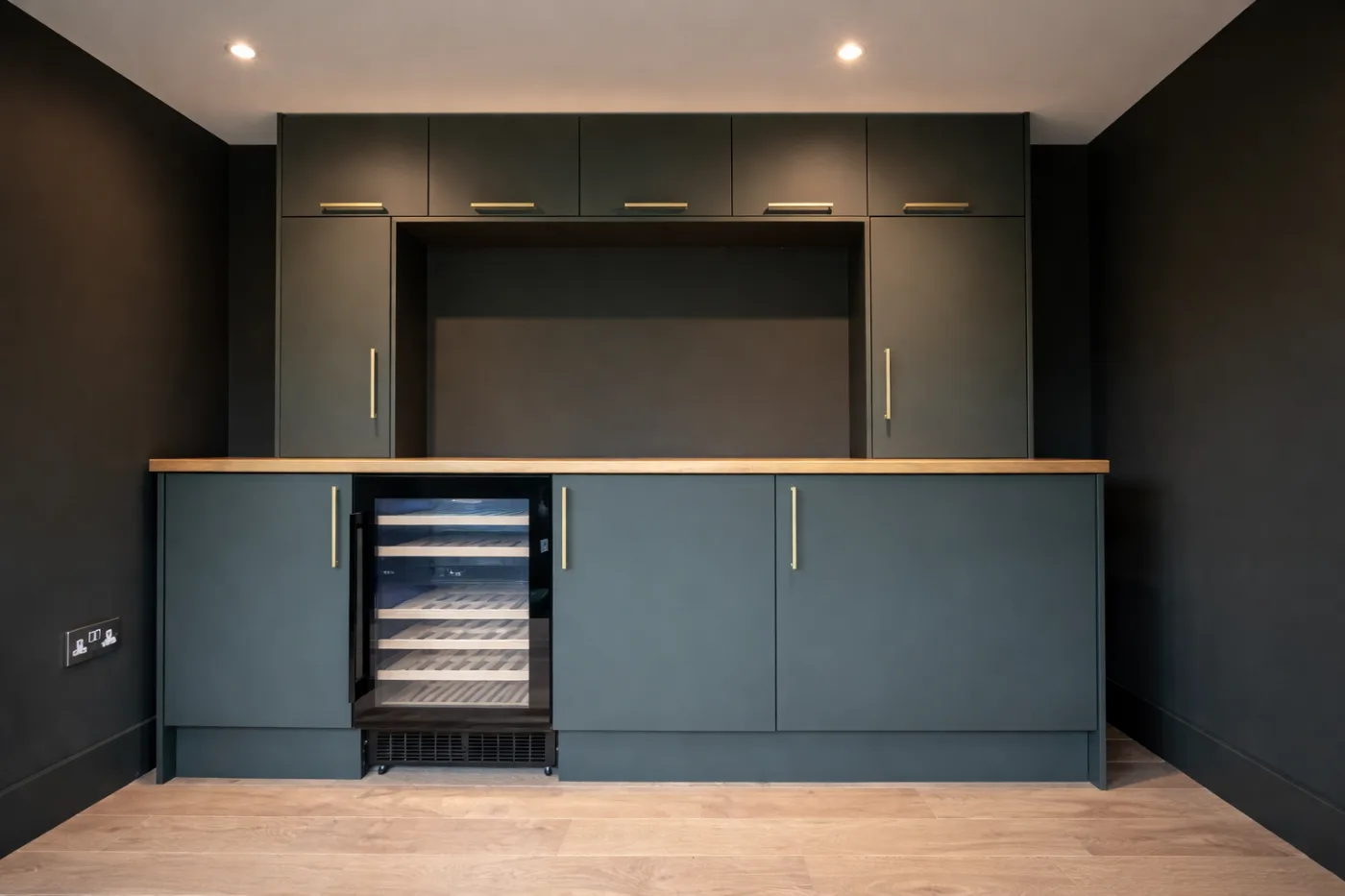 Bespoke kitchen cabinetry with timber worktop and integrated appliances in a garden room annexe