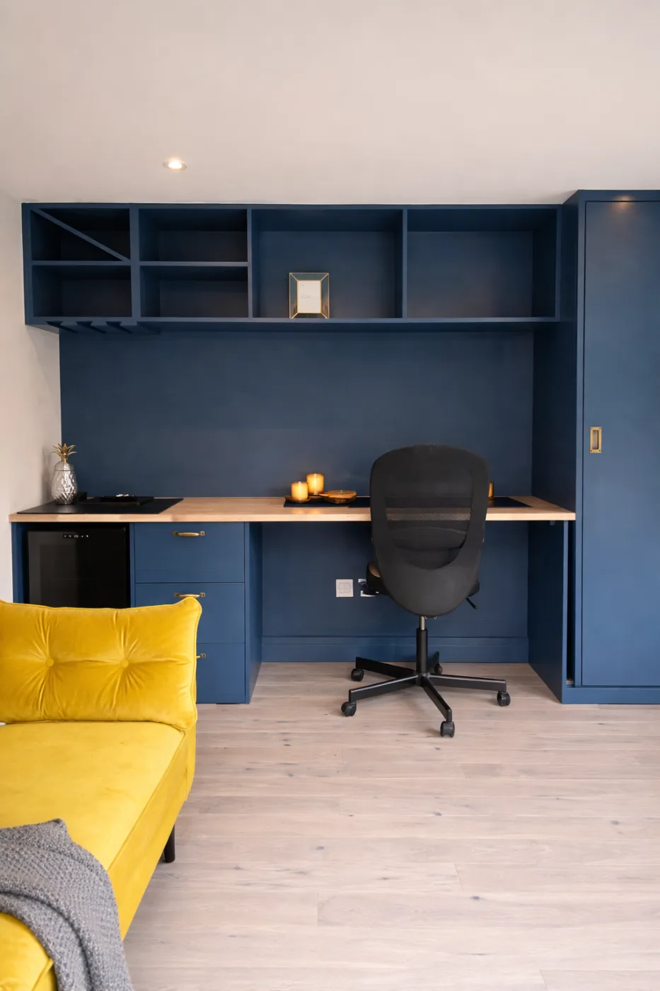 Bespoke built-in desk and workstation with shelving in a garden room study